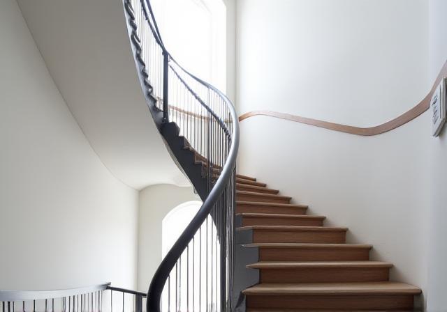 A flowing, modern interior staircase railing.